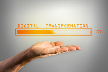 Poster - Man hand holding abstract glowing loading bar on gray wall background. Digital transformation, internet, progress and technology concept.