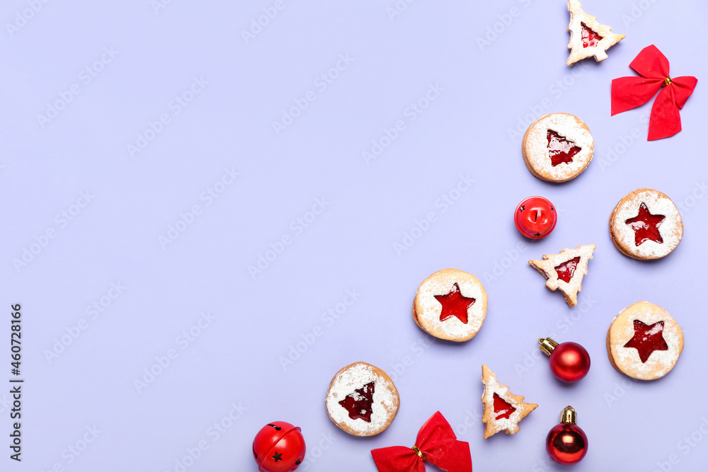 Tasty Linzer cookies with Christmas decor on color background