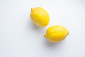 Two lemons isolated on a white background