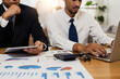 © khwanchai - legal and businessman advisor, two business people talking, planning analyze investment and marketing on laptop in office.
