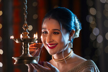 Beautiful Indian Wonam Lightning A Lamp With Diya On The Occasion Of Diwali