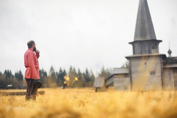 Traditional Slavic rituals in the rustic style. Outdoor in summer. Slavic village farm. Peasants in elegant robes.