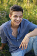 © saulich84 - sexy teen guy sitting on the grass in nature in a shirt and jeans