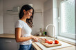 © bnenin - Adult woman, carefully cutting the tomatoes.