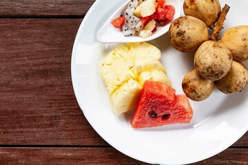 Wall Mural - Mixed fruit plate on white brown table