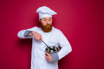 Wall Mural - doubter chef with beard and red apron is ready to cook