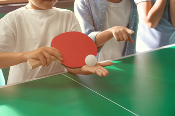 Sticker - Little boy with friends playing ping pong indoors, closeup