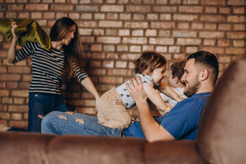 Wall Mural - Young family with their little son at home having fun