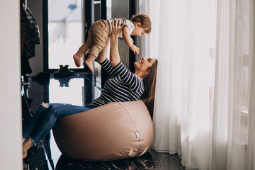 Wall Mural - Young family with their little son at home having fun