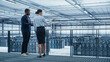 © Gorodenkoff - Data Center Female System Administrator and Male IT Specialist Talk, Use Laptop. Information Technology Engineers work on Cyber Security Network Protection in Cloud Computing Server Farm.