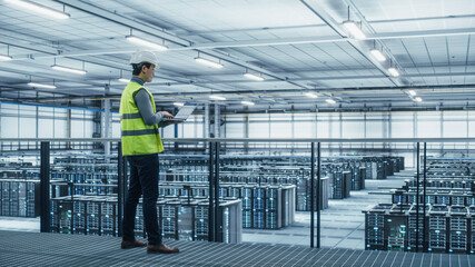 Poster - Data Center Engineer in High Visibility Vest Using Laptop Computer. Server Farm Cloud Computing Facility with Asian Male System Administrator Working with Data Protection Network for Cyber Security.