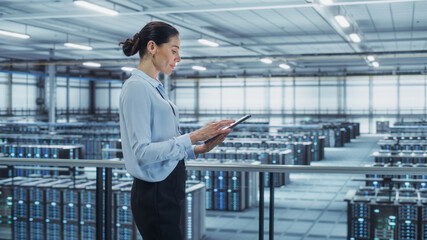 Leinwandbilder - Data Center Engineer Using Tablet Computer. Server Farm Cloud Computing Specialist Facility with Multiethnic Female System Administrator Working with Data Protection Network for Cyber Security.