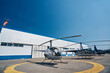 Choppers parked on helipad at metal hangar