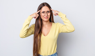 Poster - hispanic pretty woman with a serious and concentrated look, brainstorming and thinking about a challenging problem