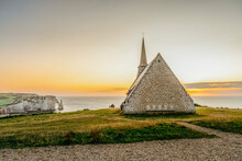 Church (Chapelle Notre-Dame-de-la-Garde) On The Cliff In The Town Of Etretat In Normandy, France During Sunset