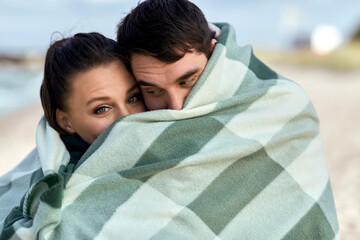 Canvas Print - love, relationship and people concept - happy smiling couple in warm blanket on autumn beach