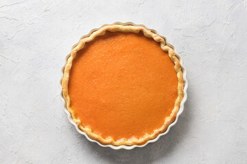 Traditional American Pumpkin Pie isolated on white background. View from above. Homemade pastry for Thanksgiving Day.