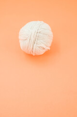 Sticker - Vertical shot of soft beige yarn balls on a yellow background