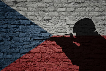 Wall Mural - Soldier silhouette on the old brick wall with flag of czech republic country.
