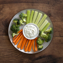 A Plate Of Raw Vegetables And Dip