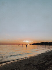 Poster - Vertical shot of a beautiful sunset at the beach