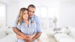 © BillionPhotos.com - Smiling mid adult couple hugging each other and standing at home