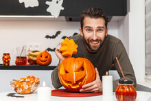 Man With A Smile Looking At The Camera Next To A Pumpkin For Halloween