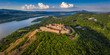 © zgphotography - Visegrad, Hungary - Aerial panoramic drone view of the beautiful high castle of Visegrad with summer foliage and trees. Dunakanyar and blue sky with clouds at background