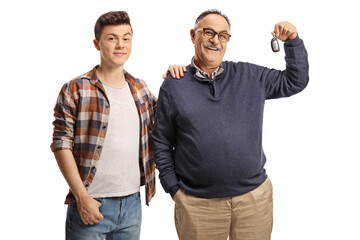 Wall Mural - Father and son with a car key, smiling and looking at camera