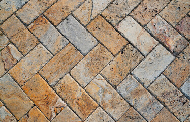 Wall Mural - Gray brown stone pavers background. Neutral texture of a flat brick wall close-up.        