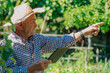 © carballo - farmer with technology device or tablet in the field pointing