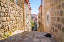 Famous Narrow Street And Old City Walls In Dubrovnik, Croatia