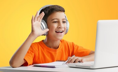 Wall Mural - Back to school. Happy little pupil at the desk. Child doing homework