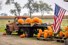 Load Truck Of Pumpkins With USA Flag Farmer Symbold At Fall