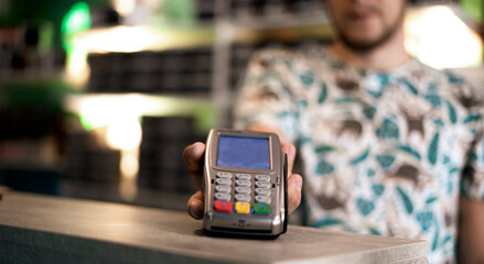 seller holding and giving the payment terminal