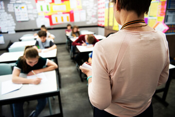 Wall Mural - students doing the exam in classroom