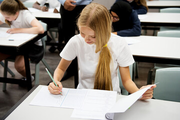 Wall Mural - students doing the exam in classroom