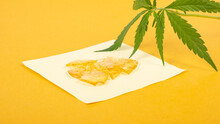 Strong Extract Of Gold Cannabis Wax With High Thc On Yellow Background Close Up