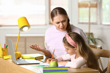 Canvas Print - Little girl with her mother doing lessons at home