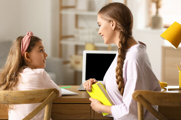 Sticker - Little girl with her mother doing lessons at home