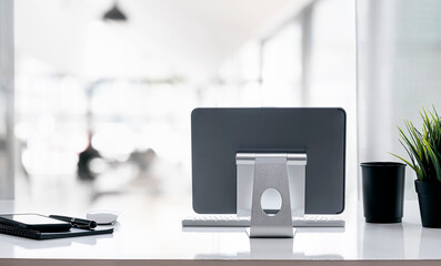 Rear view workspace with tablet on stand and supplies.