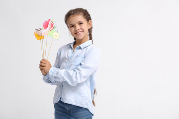 Little girl with decor for Rosh Hashanah (Jewish New Year) on white background