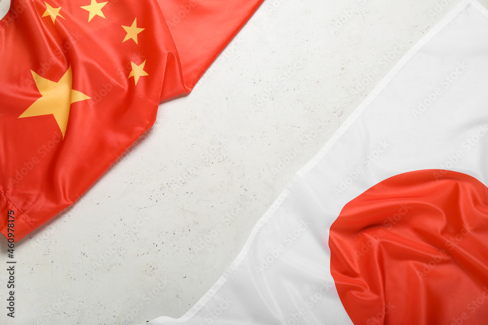 Flags of Japan and China on light background