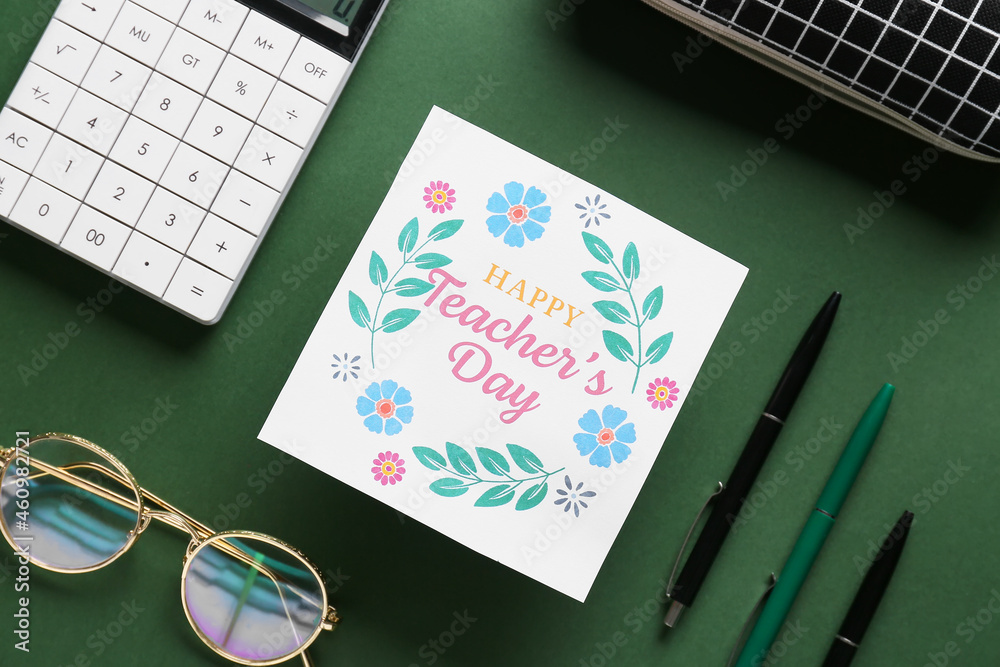 Happy Teacher's Day. Greeting card and office supplies on dark green background, top view