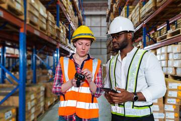 Wall Mural - A small group of warehouse workers has a briefing in a large distribution center. concept of teamwork and occupation.