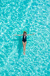© Timelapse4K - Top view aerial of a seductive sexy model in black swimwear is enjoying relax in turquoise sea summer weekend. Tropical background with empty space.