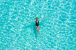 © Timelapse4K - Top view aerial of a seductive sexy model in black swimwear is enjoying relax in turquoise sea summer weekend. Tropical background with empty space.
