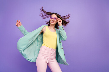 Wall Mural - Portrait of charming positive girl arm touch glasses look empty space beaming smile isolated on violet color background