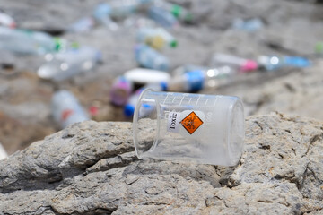 Canvas Print - hazardous chemical waste from the industry on rocks