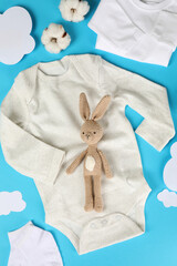 Wall Mural - Concept of cute baby clothes on blue background